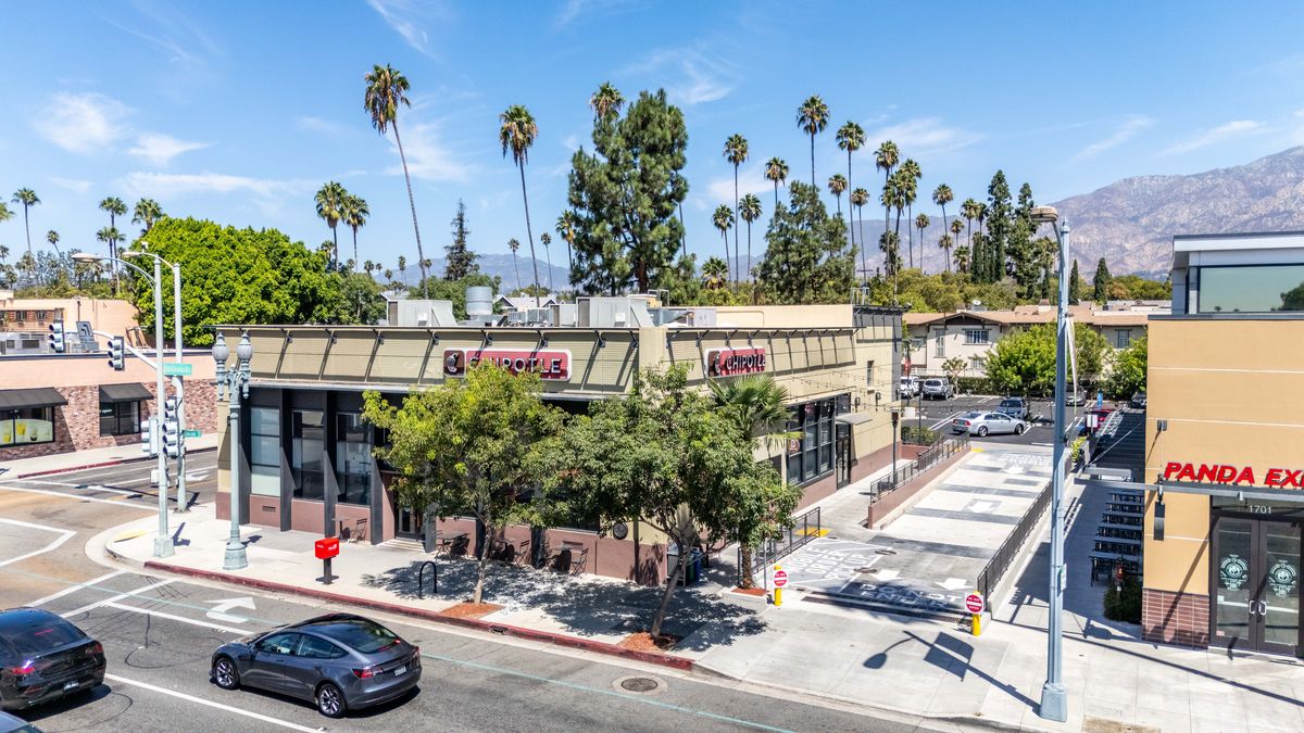 The corner building at Bonnie Avenue with Chipotle signage facing Colorado Boulevard, the driveway beside it, and the main building to the right.