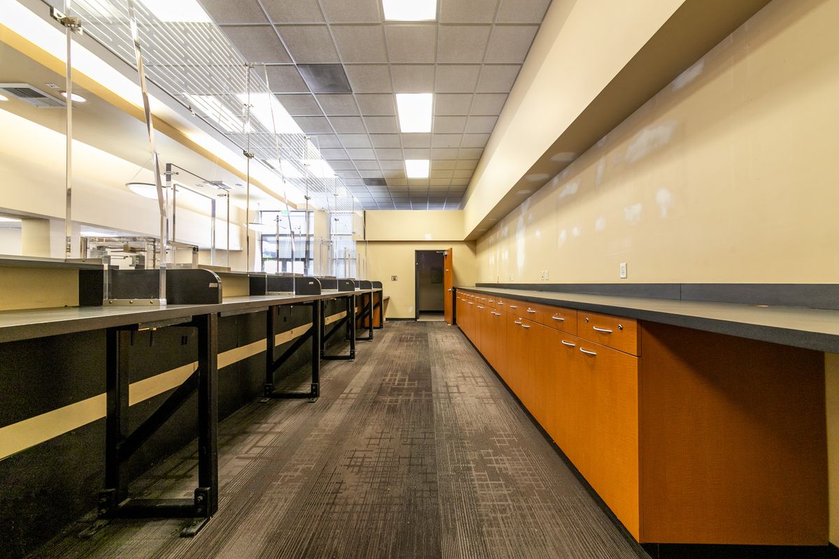 Suite 2 interior: the work area behind the counter with built-in cabinets.