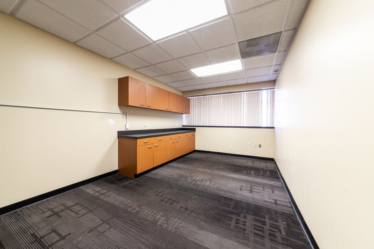 Suite 2 interior: a private office with wall cabinets and a window.